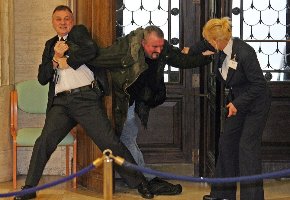 Michael Stone is held by Stormont security staff in 2006