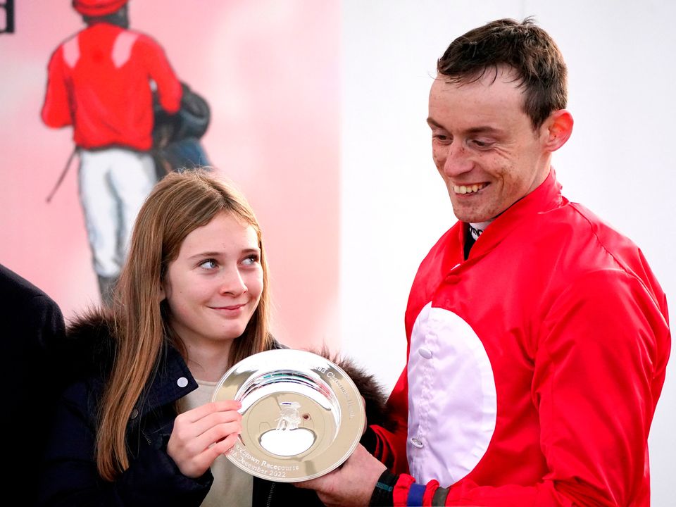 Georgia de Bromhead presents JJ Slevin with the trophy after winning the Jack de Bromhead Christmas Hurdle on Home By The Lee. Photo: Niall Carson/PA Wire.