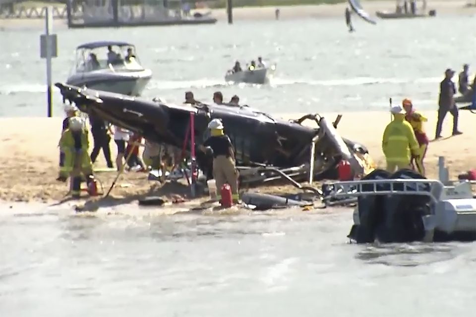 This image from a video shows a crashed helicopter on Gold Coast, Australia Monday, Jan. 2, 2023. Two helicopters collided Monday afternoon over the Australian beach.  (CH9 via AP)