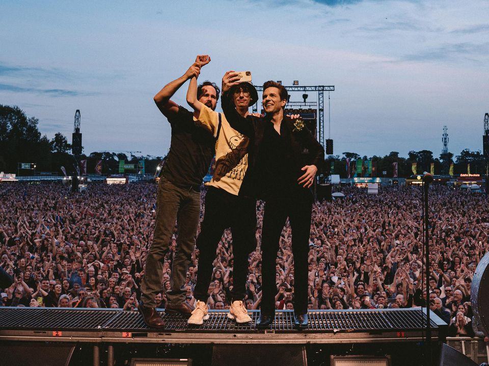 Dubliner Sam Connolly on stage at Malahide with The Killers singer Brandon Flowers, right, and drummer Ronnie Vanucci Jnr. Photo: Rob Loud