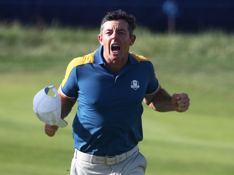 Rory McIlroy celebrates after winning his match.