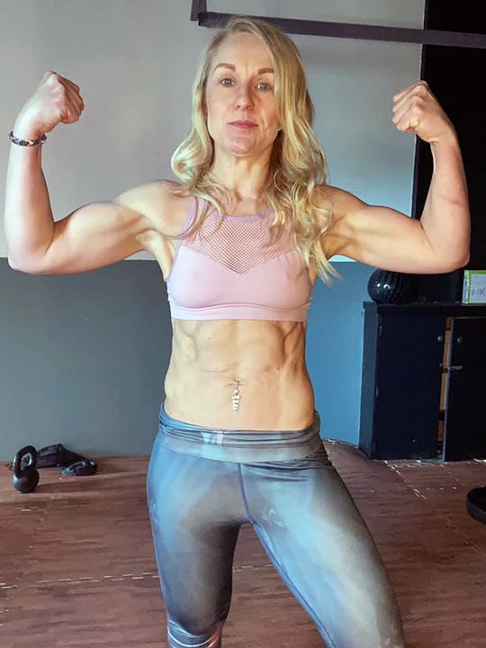 Lynn  showing off the results of her workouts
