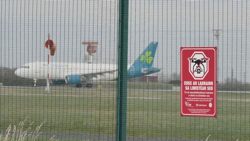 A warning sign against the use of drones on the perimeter fencing at Dublin airport (Niall Carson/PA)
