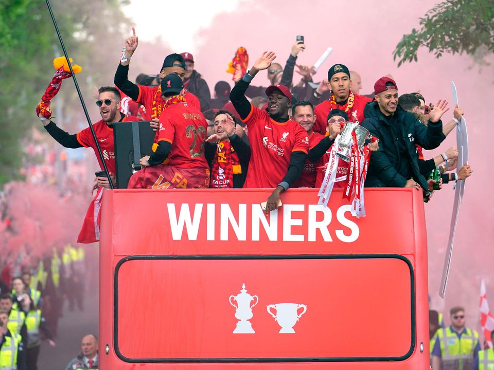 Liverpool players on an open-top bus during the trophy parade in Liverpool.