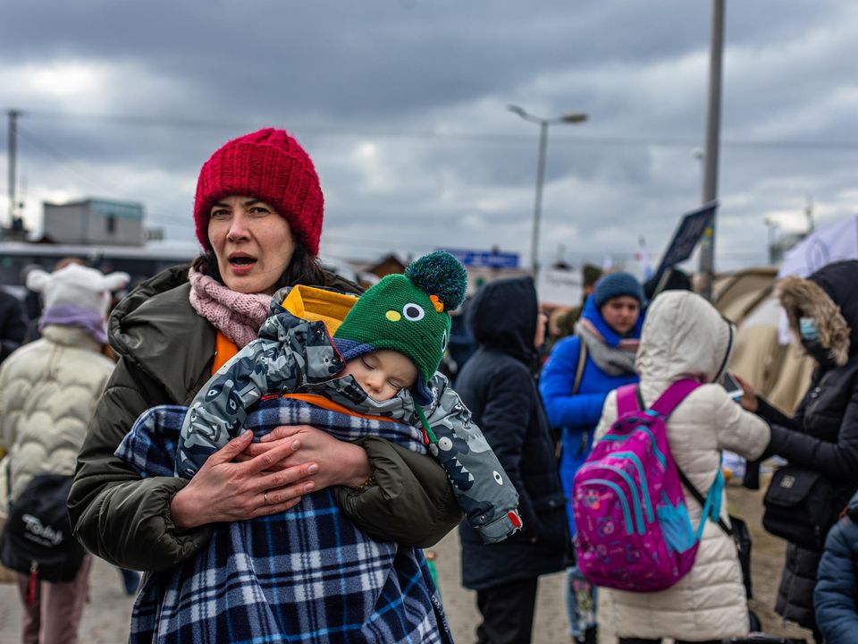 Refugees Olena Savkova with her son Misha (10 months) from the cityh of Dnipro in Ukraine who crossed the border to Poland (Photo: Mark Condren)