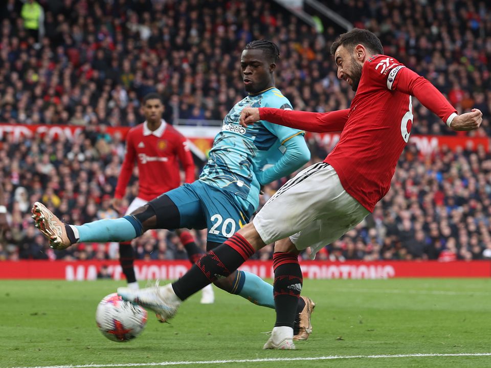 MANCHESTER, ENGLAND - MARCH 12: Bruno Fernandes of Manchester United in action with Kamaldeen Sulemana of Southampton during the Premier League match between Manchester United and Southampton FC at Old Trafford on March 12, 2023 in Manchester, England. (Photo by Matthew Peters/Manchester United via Getty Images)