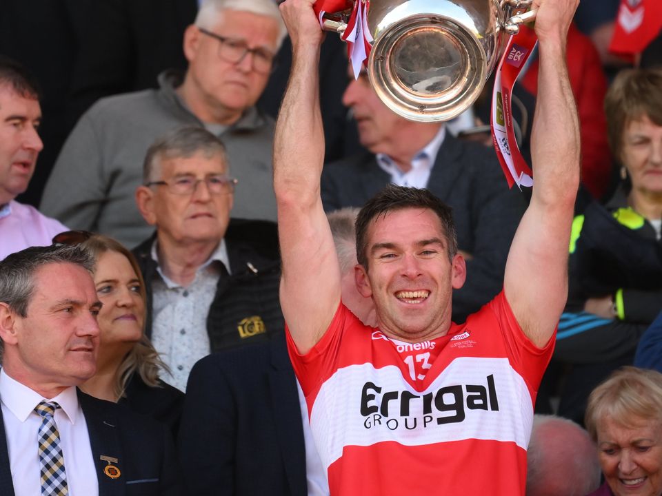 Benny Heron lifts the Anglo-Celt Cup after Derry's victory in the Ulster SF Final. Photo: Stephen McCarthy/Sportsfile