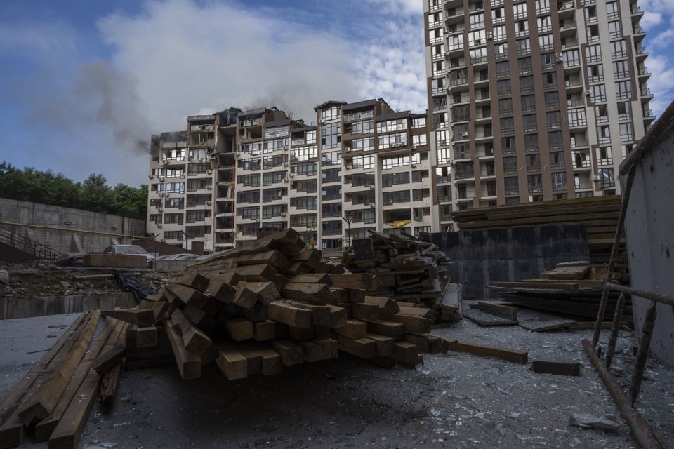 Firefighters work at a residential building in Kyiv (Nariman El-Mofty/AP)