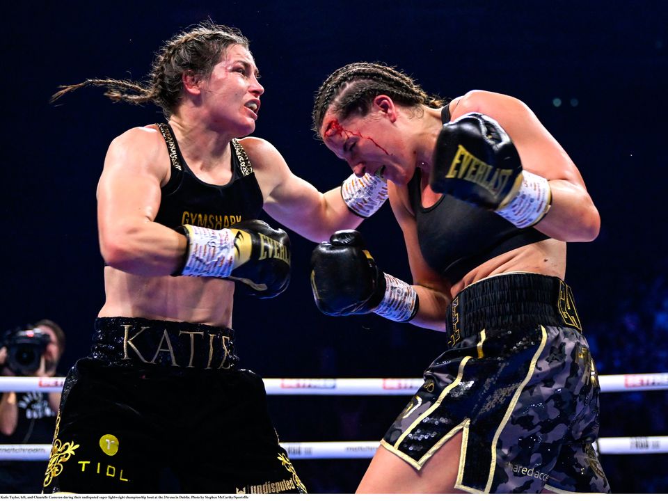 25 November 2023; Katie Taylor, left, and Chantelle Cameron during their undisputed super lightweight championship bout at the 3Arena in Dublin. Photo by Stephen McCarthy/Sportsfile