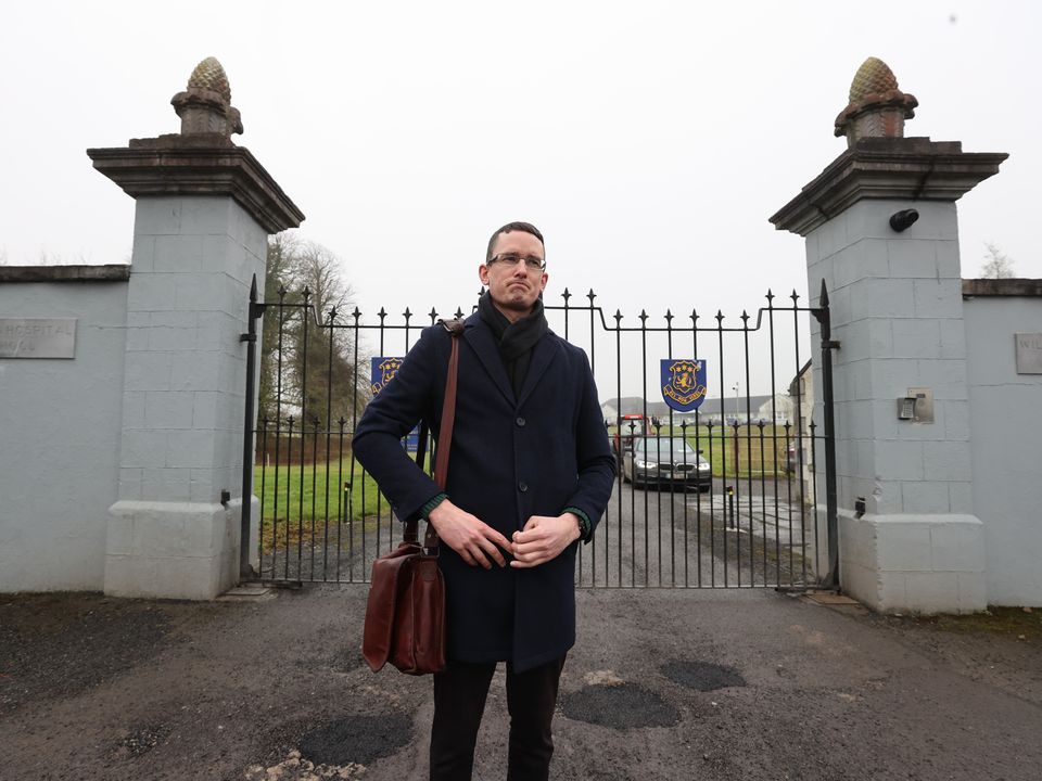 Enoch Burke stands outside the locked gates of Wilsons Hospital School, Multyfarnham following his release from Mullingar Garda station.   Picture; Gerry Mooney