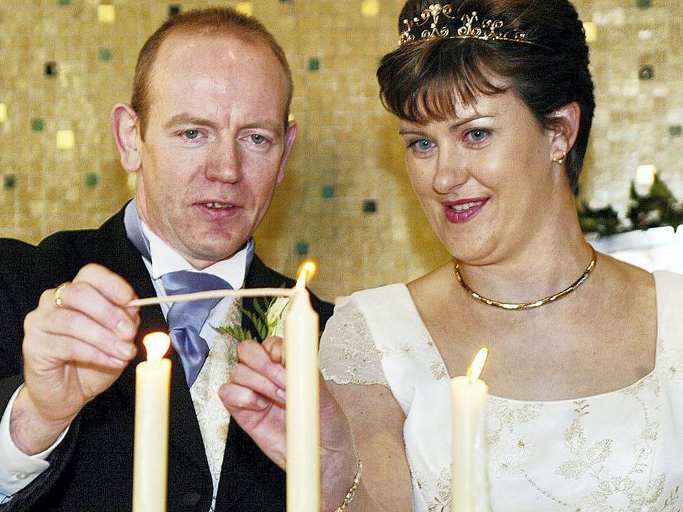 Pearse McAuley and Pauline Tully light a candle after their wedding in Kilnaleck, Co Cavan, in 2003. Photo: John McAviney