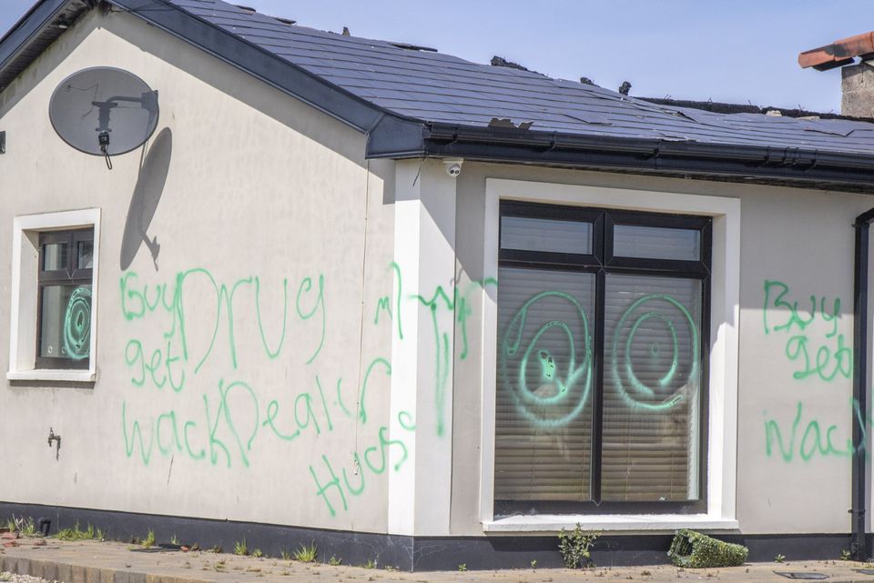 The torched house has been covered with graffiti. Photo: NW Newspix