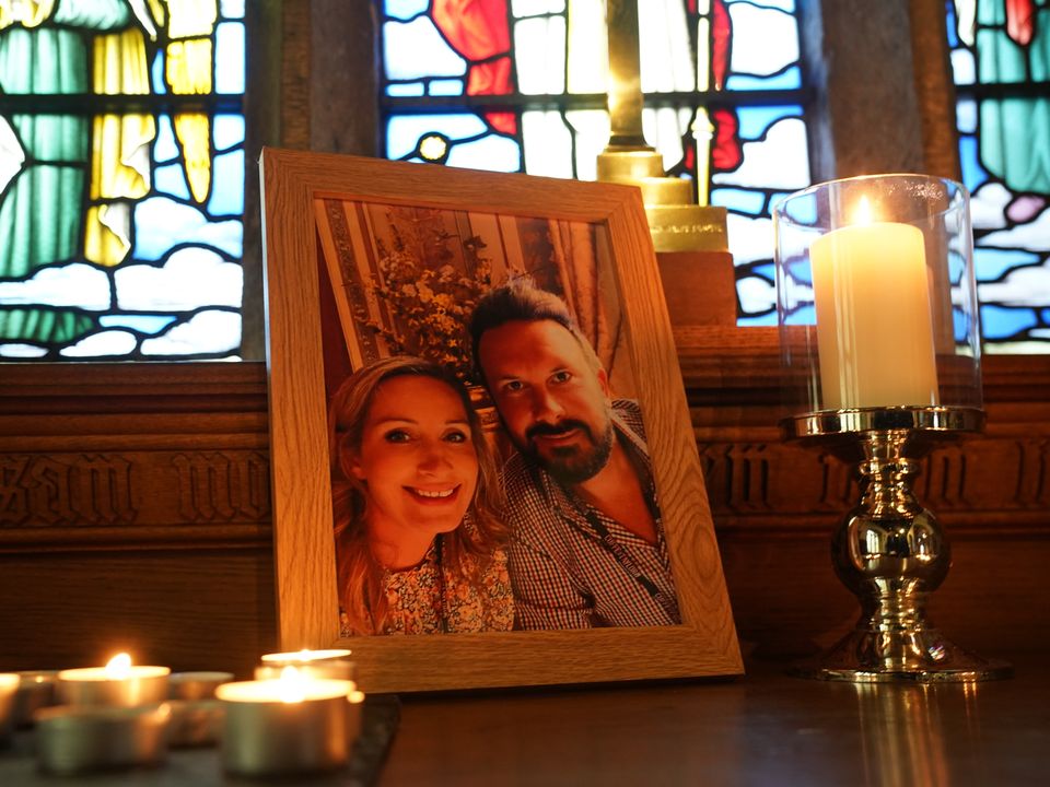 Candles are lit around a photo of Nicola Bulley and her partner Paul Ansell on an altar at St Michael’s Church in St Michael’s on Wyre, Lancashire (PA)