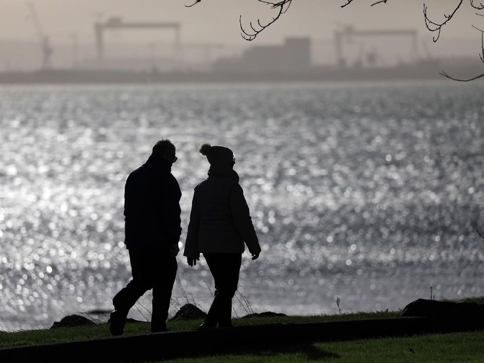 A couple brave the elements during a walk along the sea front at Jordanstown on Saturday. Picture: Peter Morrison