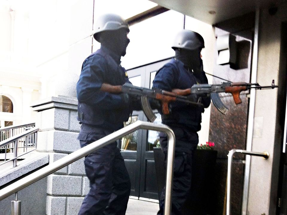 Raiders disguised as Garda armed with AK47 Assault Rifles enter the front door of THe Regency Hotel