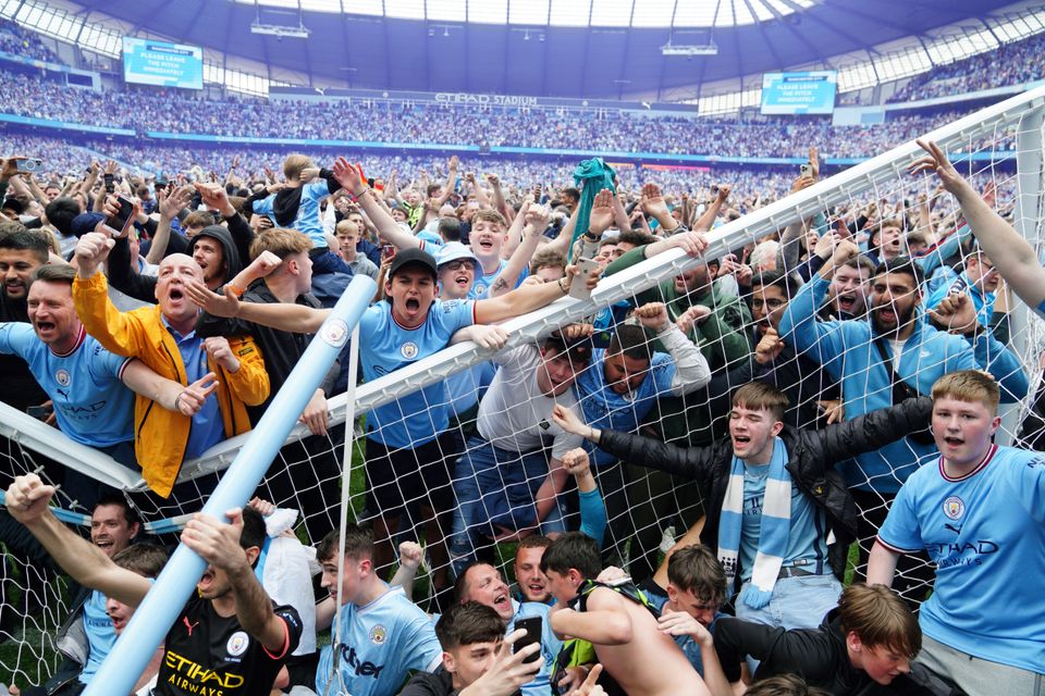 Manchester City fans invaded the pitch at full-time (Martin Rickett/PA)