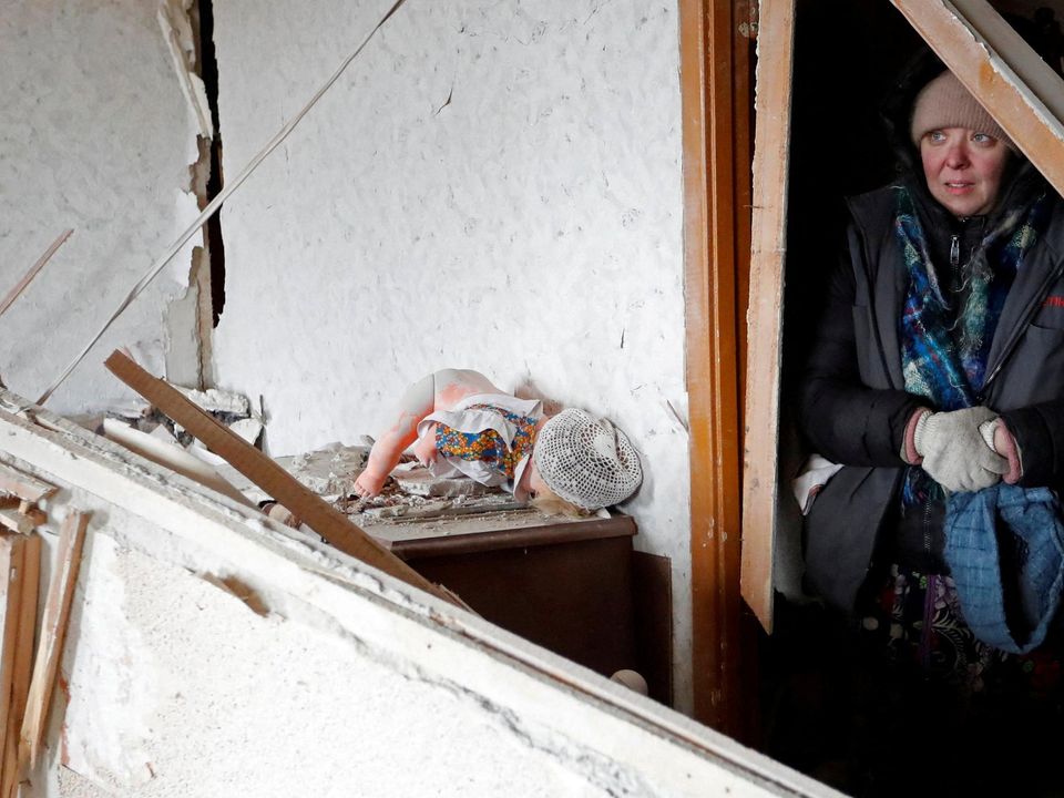 A resident of Mariupol cowers inside a damaged apartment in the besieged port city as battles raged yesterday. Photo: Reuters/Alexander Ermochenko