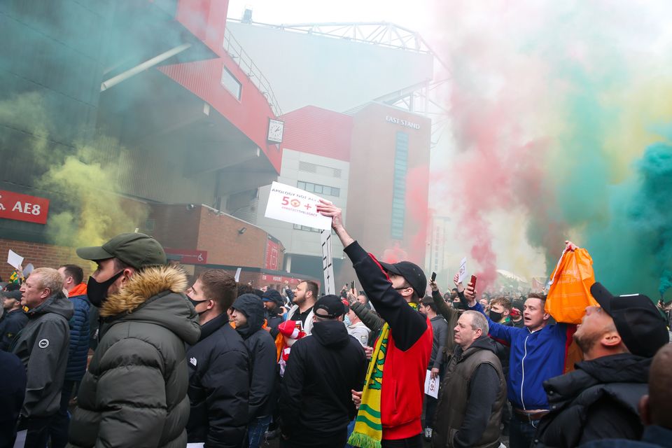 Manchester United fans protest at Old Trafford last April before breaking into the ground and forcing their game against Liverpool to be postponed (Barrington Coombs/PA)