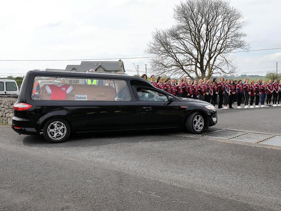 Athenry camogie team mates look on as the hearse carrying the remains of Kate Moran arrives at the Church of The Sacred Heart in Ryehill, Monivea, Co Galway. Picture: Frank McGrath