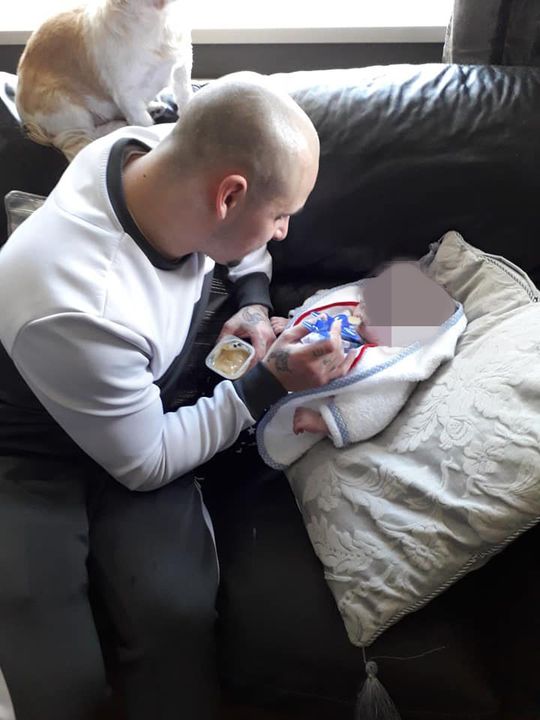 James McVeigh feeding his baby son