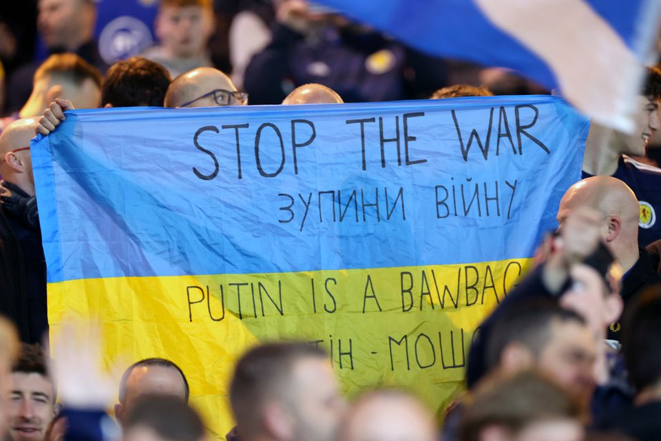 Scotland fans hold up a Ukraine flag reading ‘Stop the War’ (Steve Welsh/PA)