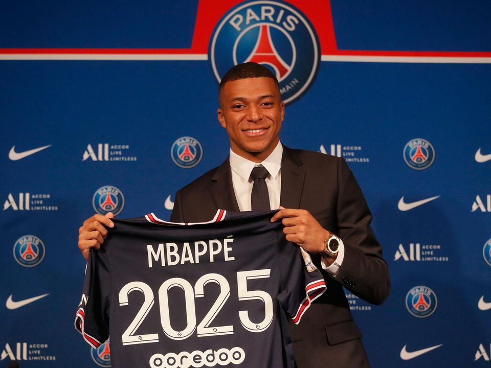 PSG striker Kylian Mbappe shows his jersey during a press conference