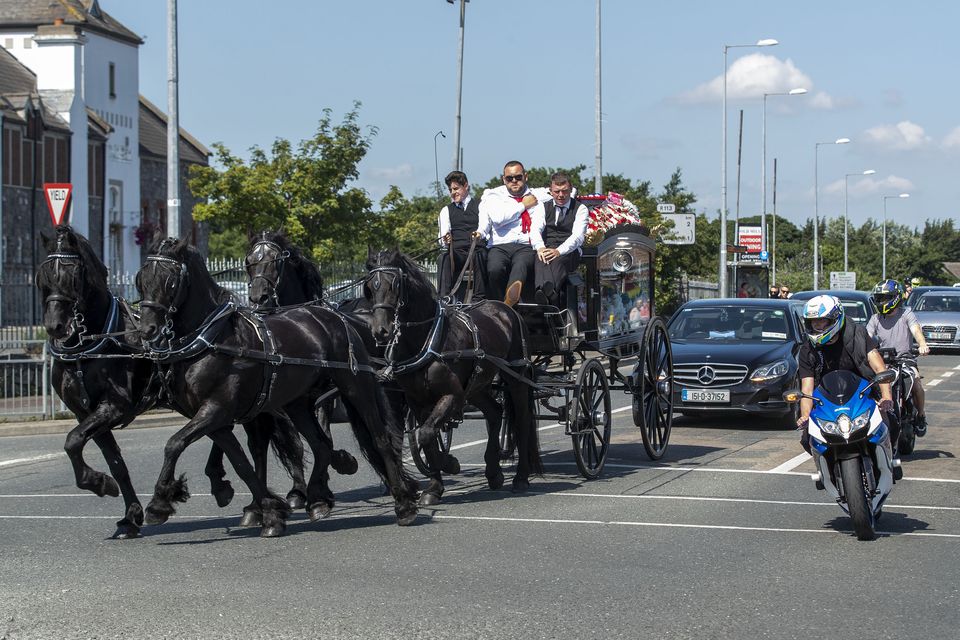 A horse-drawn hearse carrying the coffin of Graham Taylor, who was killed in the pursuit on the M7.
