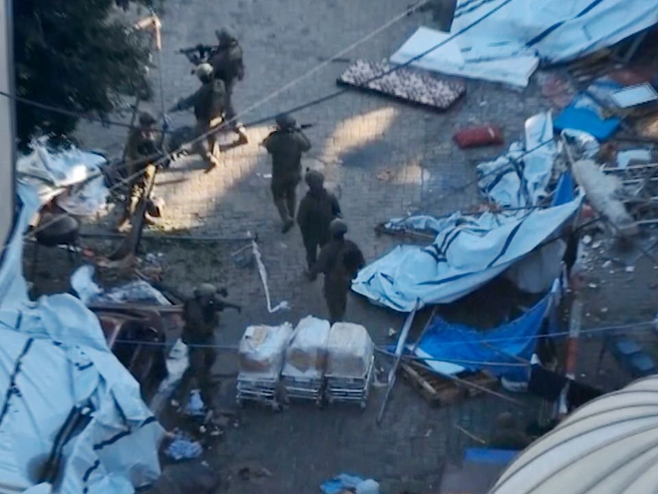 In this image taken from a video released by the Israeli Defense Forces on Tuesday, Israeli soldiers are seen walking in the area of Al-Shifa hospital in Gaza City
