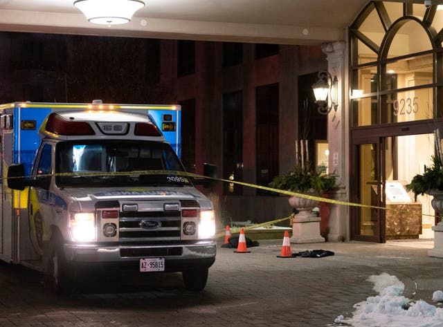 An ambulance is parked outside the lobby of a condominium building following a fatal shooting in Vaughan, Ontario
