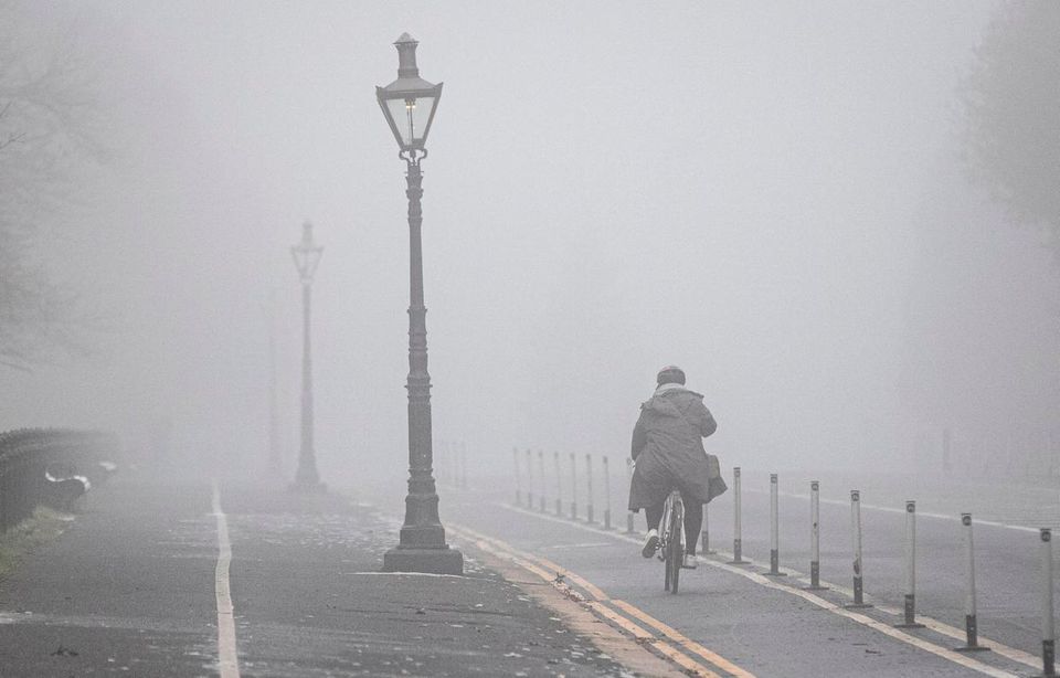 People navigate thick fog in Dublin City as the Irish Met office issued an orange level Freezing fog warning. Photo: Damien Storan/PA Wire.