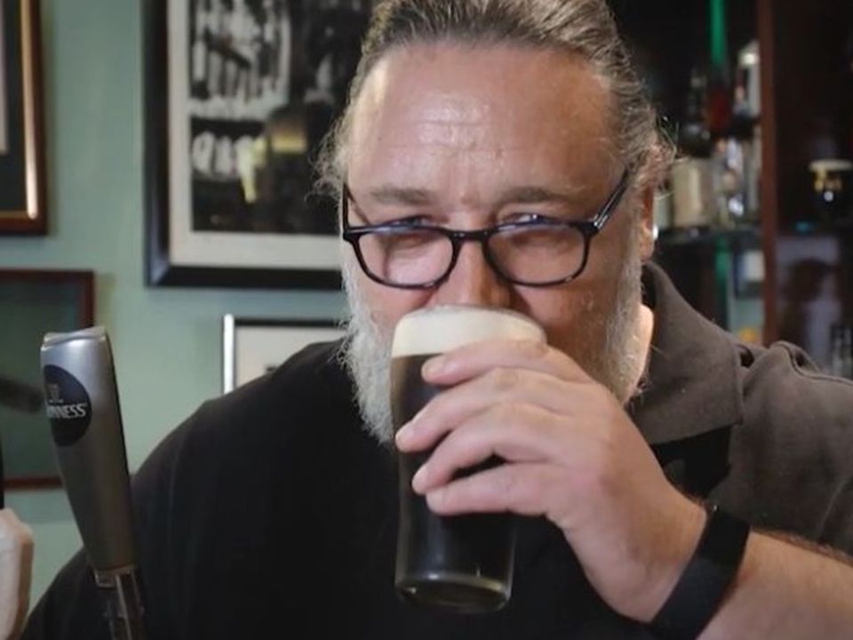 Russell enjoys a pint of Guinness.