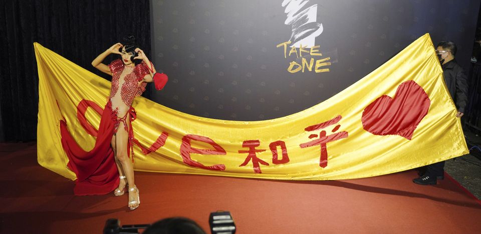 Chinese-American actress Bai Ling poses with her slogan ‘Love, Peace’ at the 57th Golden Horse Awards in Taipei (Billy Dai/AP)