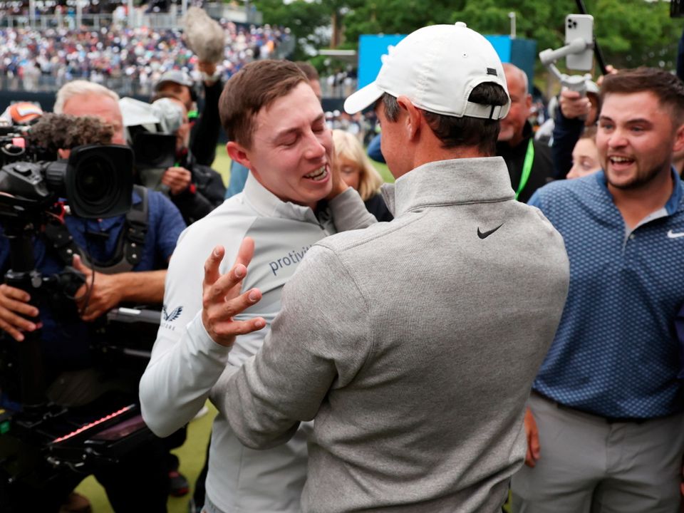 Matt Fitzpatrick of England is congratulated on his win by Rory McIlroy