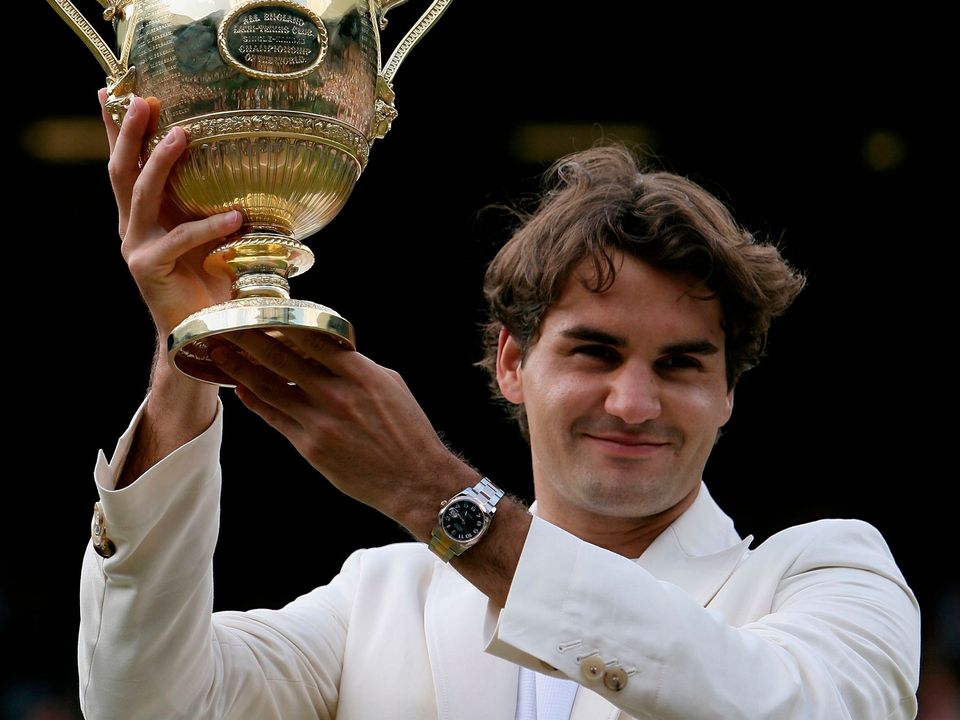 (FILE PHOTO) Roger Federer to retire after Laver Cup in September LONDON - JULY 09:  Roger Federer of Switzerland holds aloft the trophy after winning then Men's final against Rafael Nadal of Spain on day thirteen of the Wimbledon Lawn Tennis Championships at the All England Lawn Tennis and Croquet Club on July 9, 2006 in London, England.  (Photo by Clive Brunskill/Getty Images)