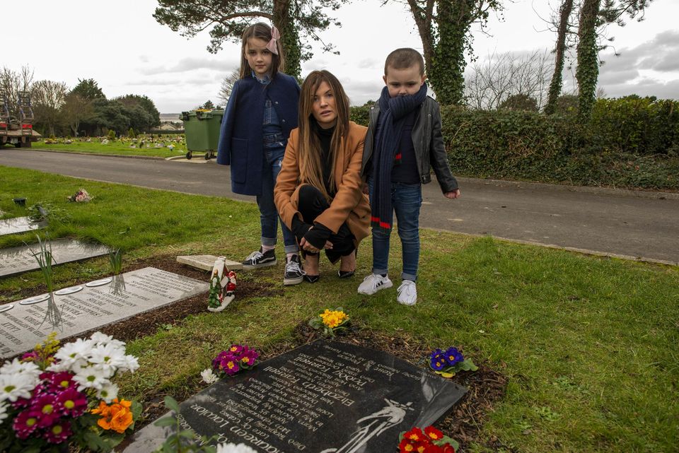 Lisa Lawlor and her two children Frankie (8) and Lennon (4) at the graves of her parents who died in the Stardust Tragedy in 1981 when Lisa was 17 months old