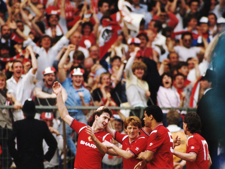 LONDON, UNITED KINGDOM - MAY 18: Goalscorer Norman Whiteside (l) is congratulated by team mates Gordon Strachan, Paul McGrath and Mike Duxbury (r) after scoring the winning goal during the 1985 FA Cup Final between Manchester United and Everton at Wembley Stadium on May 18, 1985 in London, England (Photo by David Cannon/Allsport/Getty Images)