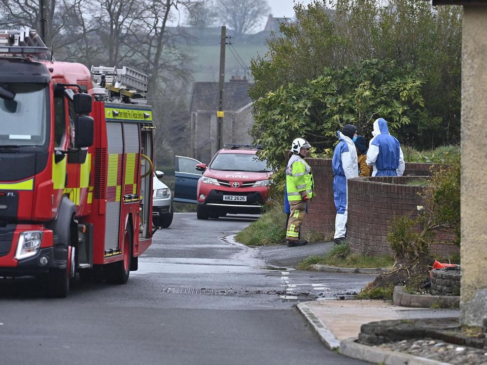 Police and the fire service at the scene of a blaze on the Manse Road in Carryduff on Tuesday (Picture: Colm Lenaghan/Pacemaker)