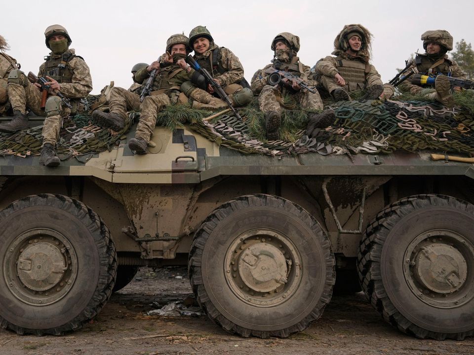 Ukrainian servicemen driving through a Russian position overrun by Ukrainian forces outside Kyiv, Ukraine yesterday. Photo: Vadim Ghirda/AP