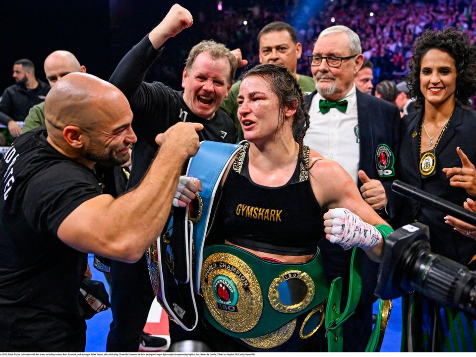 25 November 2023; Katie Taylor celebrates with her team, including trainer Ross Enamait, and manager Brian Peters, after defeating Chantelle Cameron in their undisputed super lightweight championship fight at the 3Arena in Dublin. Photo by Stephen McCarthy/Sportsfile