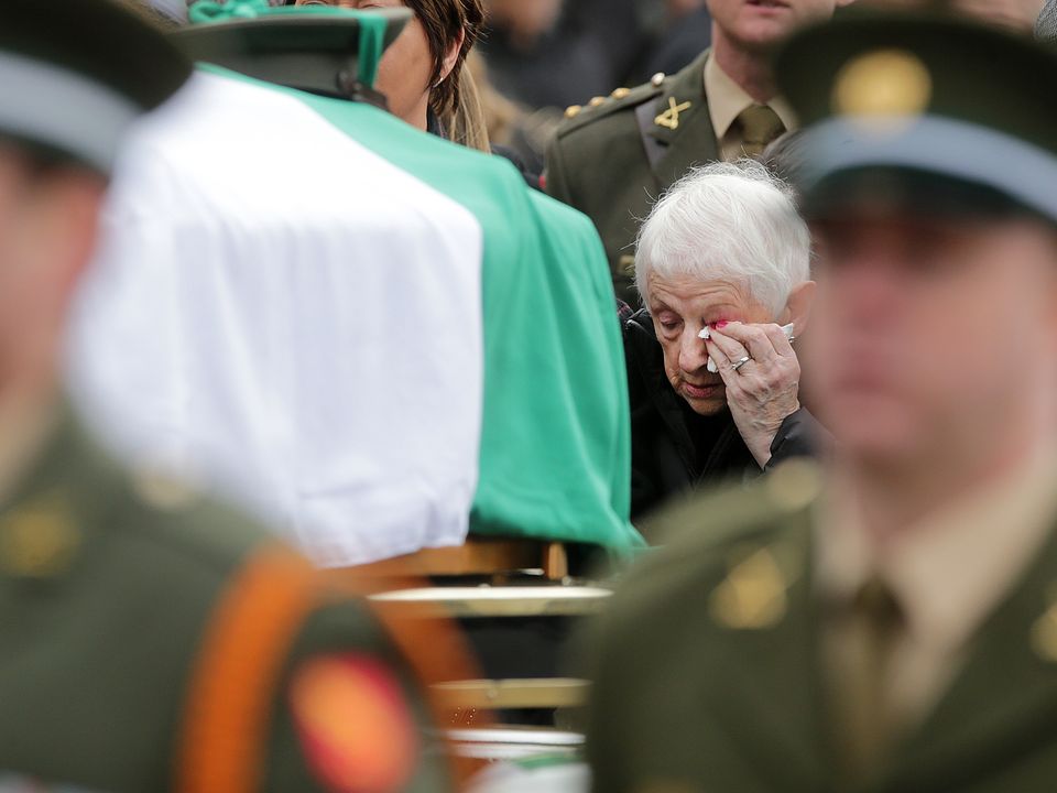 Mary O'Connell follows the remains of her son Acting Sergeant Major Declan O'Connell following his funeral mass in St Brigids Church in the Curragh Camp . Picture; Gerry Mooney