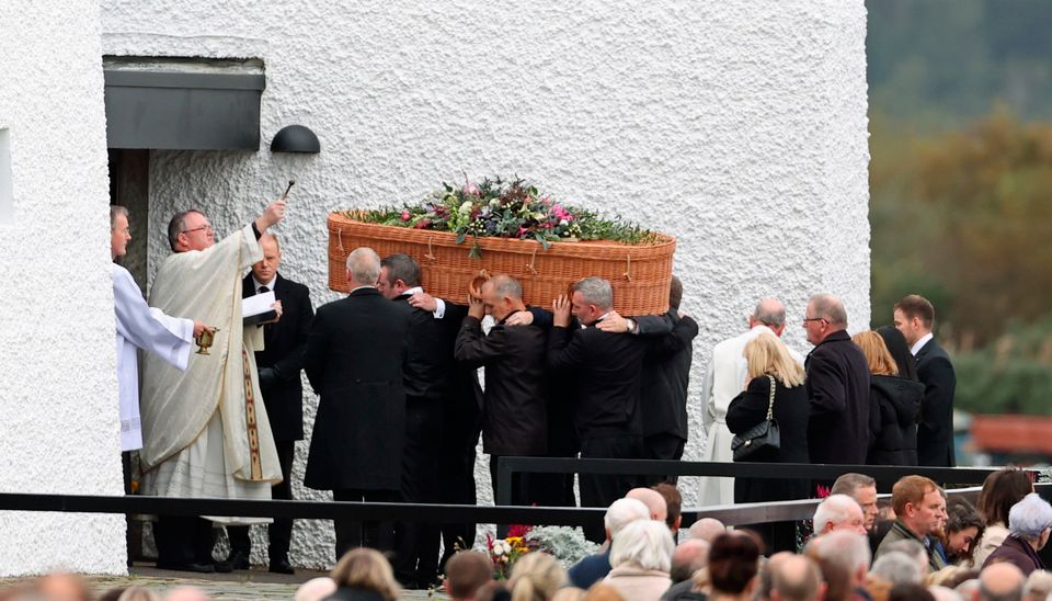 Priest Fr John Joe Duffy sprinkles holy water on the coffin of Jessica Gallagher as it arrives at St Michael's Church, Creeslough, for her funeral mass. PA