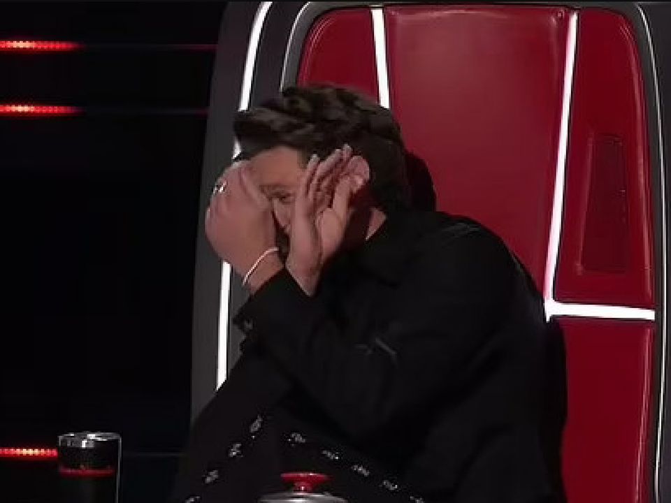 Niall Horan blocks his face on The Voice