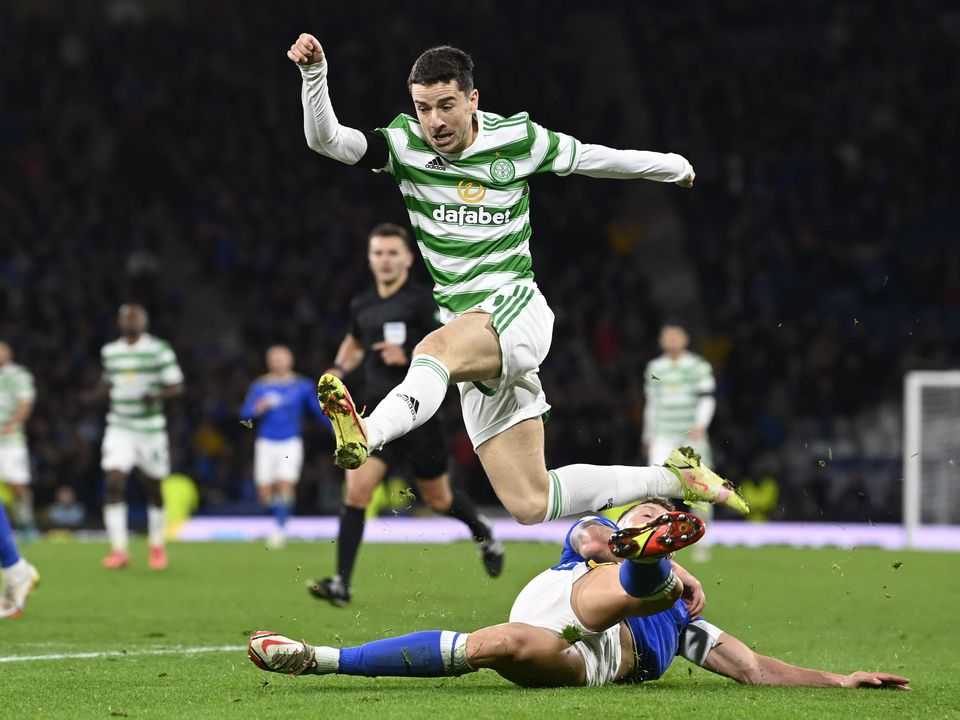 Celtic's Mikey Johnston skips away from St Johnstone's Liam Gordon. Photo: Getty Images