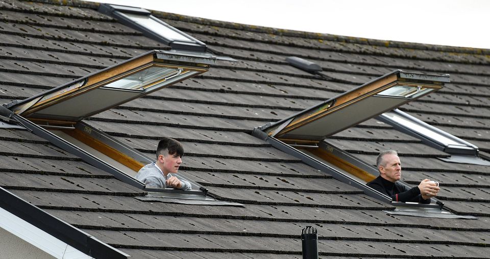 Supporters watch on from their home during the match between Galway and Mayo