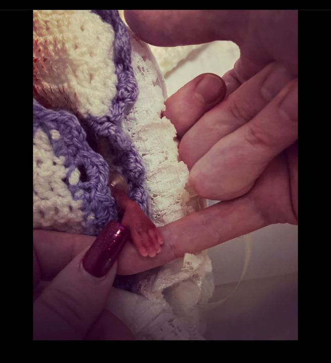 Mammy Gillian and Daddy Cathal holding baby Danny's tiny hand