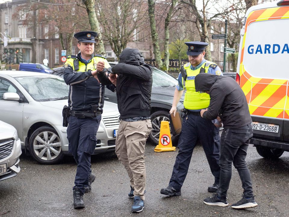 Rabah Kouchih, second left, and Fouad Mekhazni, far right, pictured arriving at Killarney District Court on Tuesday escorted by uniformed gardaí