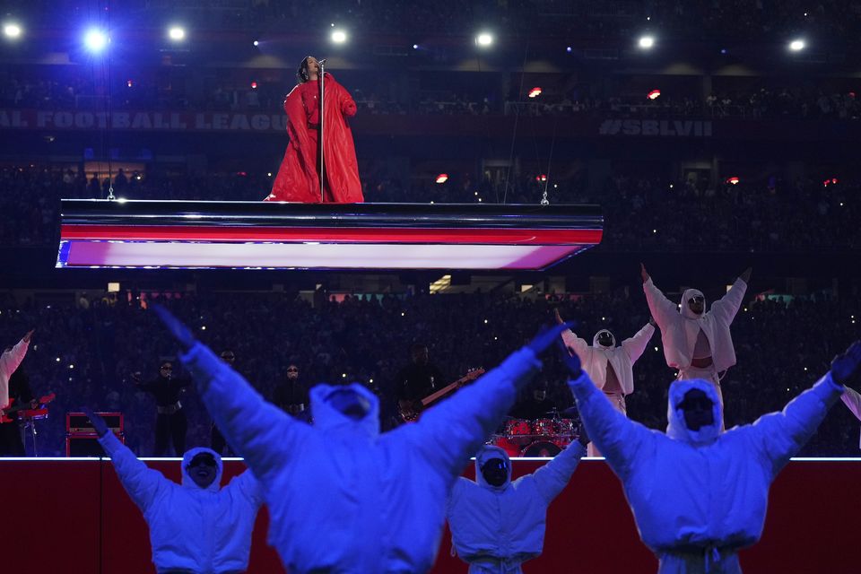 Rihanna kicked off the live performance, her first in seven years, suspended high above the stadium, dressed in all red (Matt Slocum/AP)