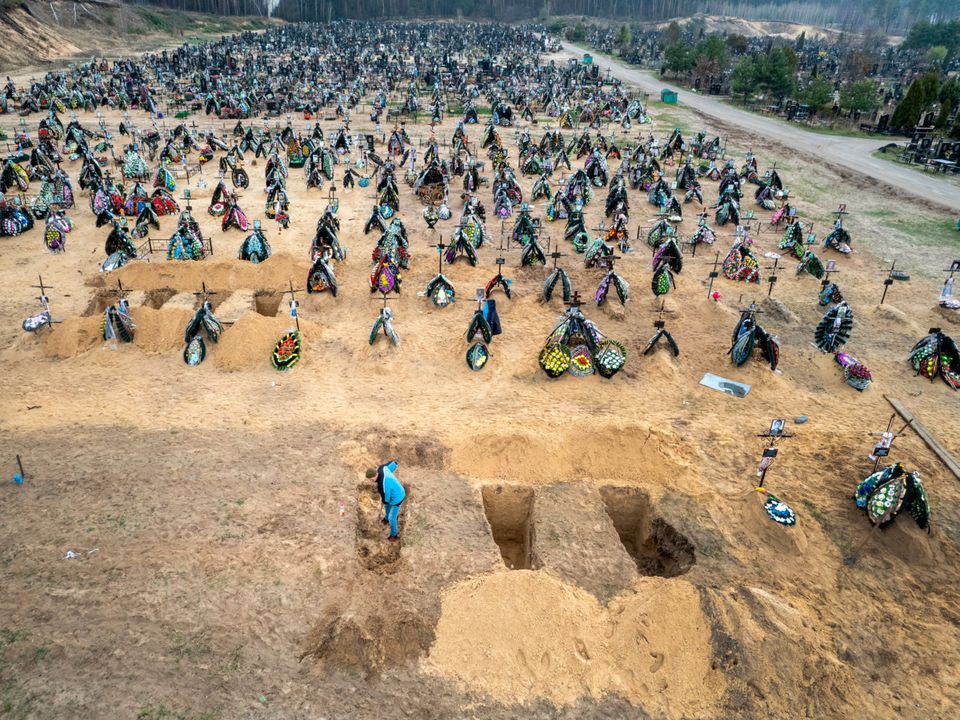 A grave digger prepares the ground for a funeral at a cemetery in Irpin, Ukraine (Photo by John Moore/Getty Images)