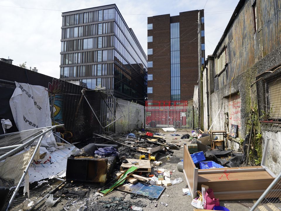 The remains of a camp in Sandwith Street, Dublin, following a protest on Friday night where it was dismantled and later set alight (Niall Carson/PA)