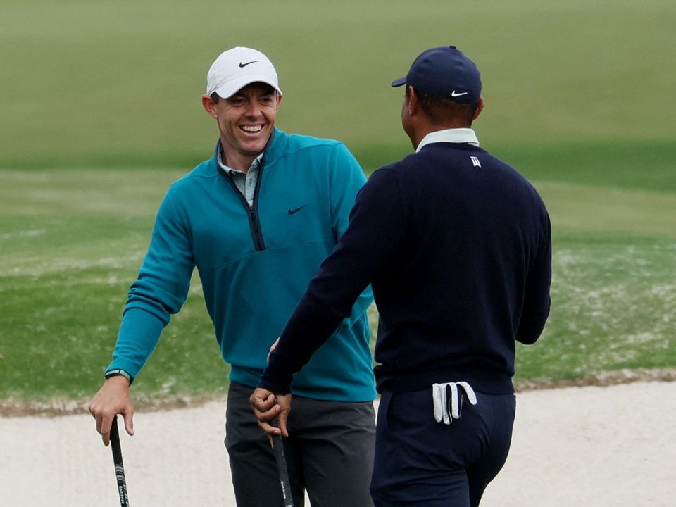 Rory McIlroy and Tiger Woods talk on the 10th tee during a practice round at The Masters at Augusta National Golf Club, Augusta, Georgia